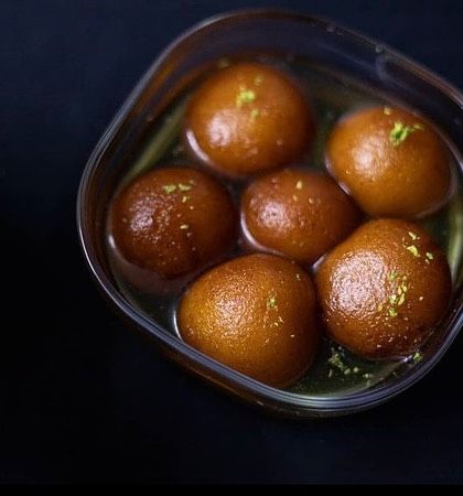 A bowl of our irresistible Gulab Jamuns, soaked in sweet syrup and garnished with pistachio. Best served warm.