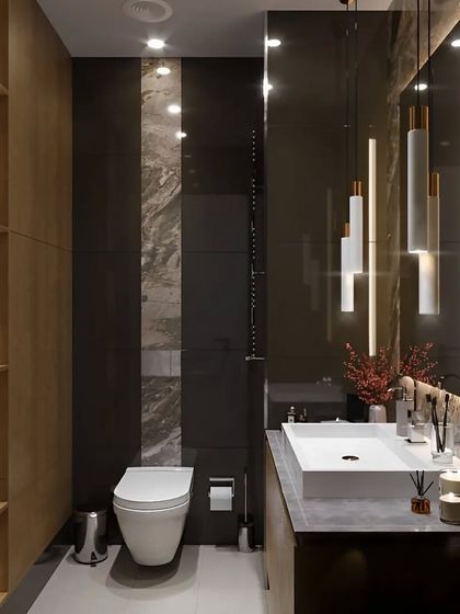 A dramatic and moody bathroom design with dark, large-format tiles and strategic accent lighting. The built-in wooden shelving adds warmth and a place for storage and display.