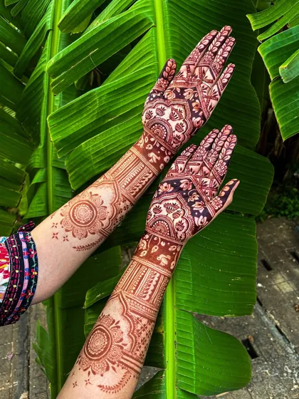 The result of our 100% organic, self-made henna paste. This photo shows the deep, rich maroon stain after it has fully matured, set against a natural backdrop to highlight its true color.