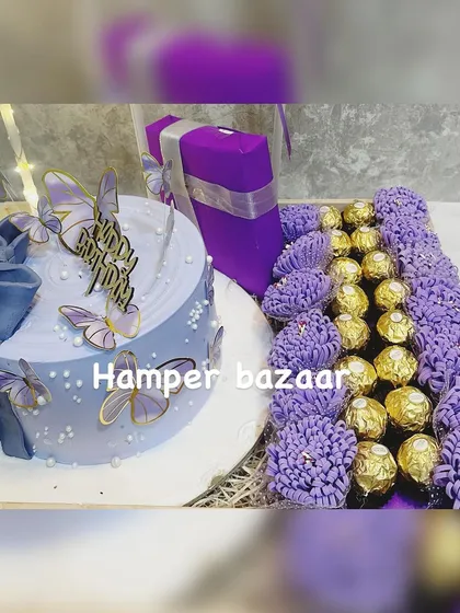 A luxurious birthday or anniversary hamper featuring a stunning lavender butterfly cake and a beautiful arrangement of Ferrero Rocher chocolates.