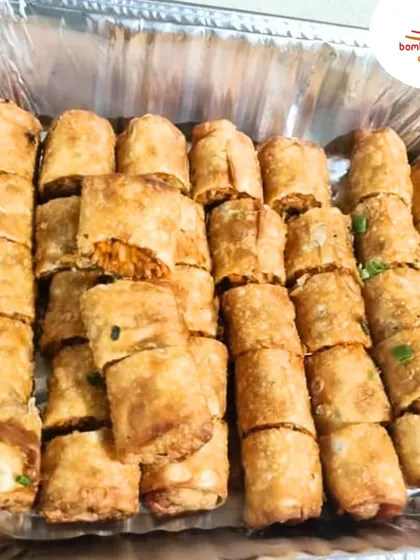 Appetizers are a popular choice for our bulk delivery. Here's a tray of our crispy vegetable spring rolls, perfectly fried and ready to be enjoyed at your home party or gathering.
