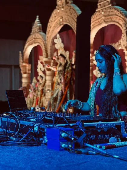 I fully immerse myself in the theme of an event. Here I am, dressed in traditional attire and lost in the music during a beautiful Durga Puja Dandiya night.