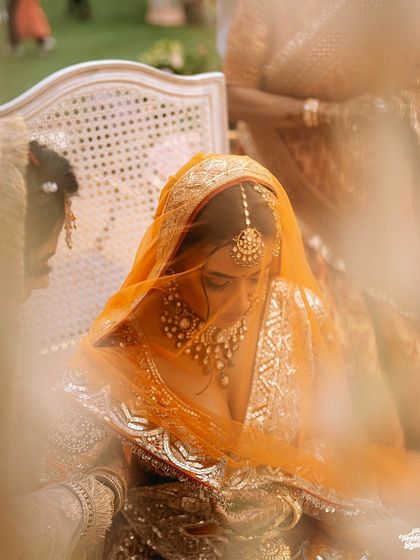 A soft-focus shot of the bride under her veil during the ceremony, creating a dreamy and intimate bridal portrait.
