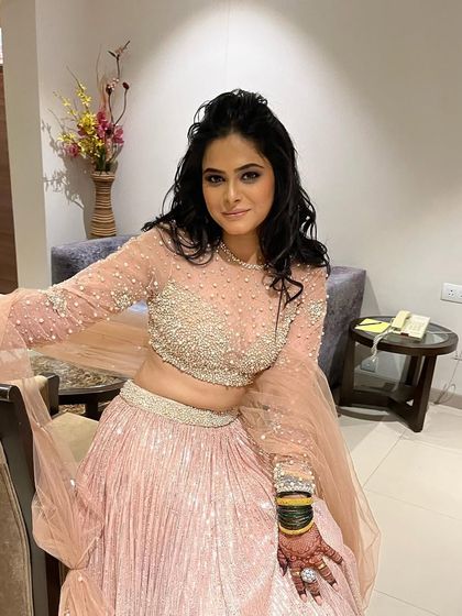 Pretty princess Pradnya in her full sangeet attire. The light pink lehenga is beautifully detailed, and her makeup is soft and glamorous.