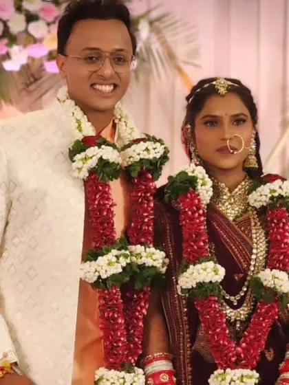 A formal portrait of the couple, looking regal and elegant in their wedding attire.