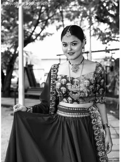 A timeless black and white portrait that emphasizes emotion and form. By removing color, the focus shifts to the model's graceful pose and the intricate patterns of her traditional Indian outfit.