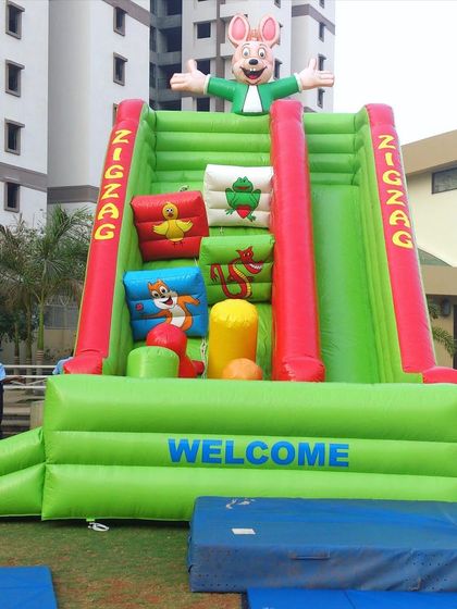 The Zig Zag Slide is a unique inflatable climber that challenges kids to navigate soft, cushioned obstacles to reach the top. It's a great alternative to a standard slide for active children.