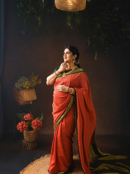 A thoughtful portrait under soft lighting. The simple, rustic setting allows the beauty of the mom to be and her traditional attire to shine.