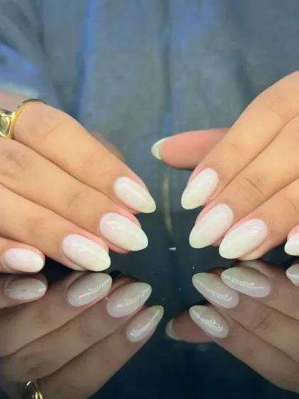 A full view of the chic and minimalist milky white nails.