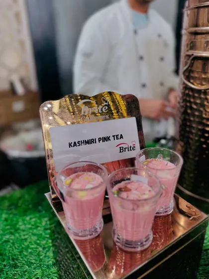 A tray of Kashmiri Pink Tea, a unique and delicious beverage, beautifully presented in small glasses.