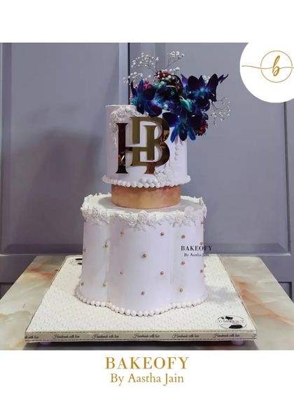 This was a massive 10kg truffle cake for a reception ceremony. The bottom tier has a unique scallop shape, and the whole cake is adorned with beautiful orchids. I take so much pride in crafting these large cakes for your special occasions.