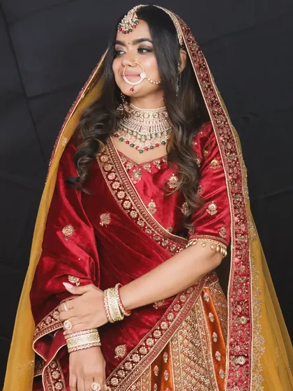 This three quarter view shows the rich texture of the velvet blouse and the detailed embroidery on the dupatta.