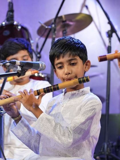 Young boys in our bansuri class, learning together and performing on stage.
