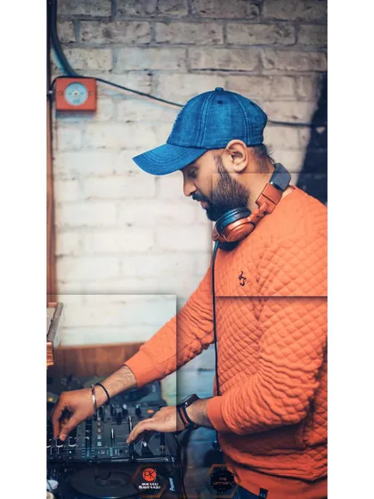 Mixing tracks at a venue with a rustic, industrial feel. I can set up and adapt my performance to suit any location, from a grand ballroom to a trendy bar.