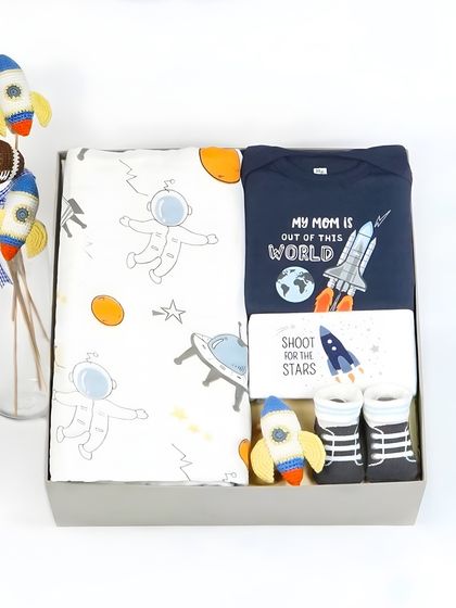 The space-themed gift set packed in a box with cute rocket props. This shows the final presentation of the hamper.