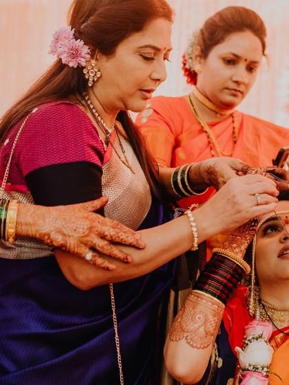 A ritual from a Maharashtrian wedding, where the bride is blessed by her family.
