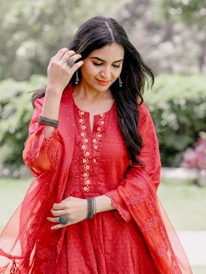 A thoughtful, candid portrait during a pre-wedding shoot. The natural outdoor light and relaxed pose make for an authentic and beautiful image.