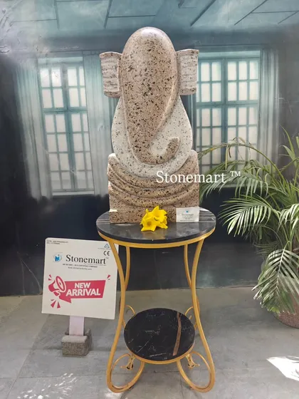 This is our modern abstract Ganesha sculpture, a contemporary take on a beloved deity. Carved from granite with a unique speckled finish, this 21-inch statue serves as a distinctive art piece for modern homes, gardens, or office spaces.