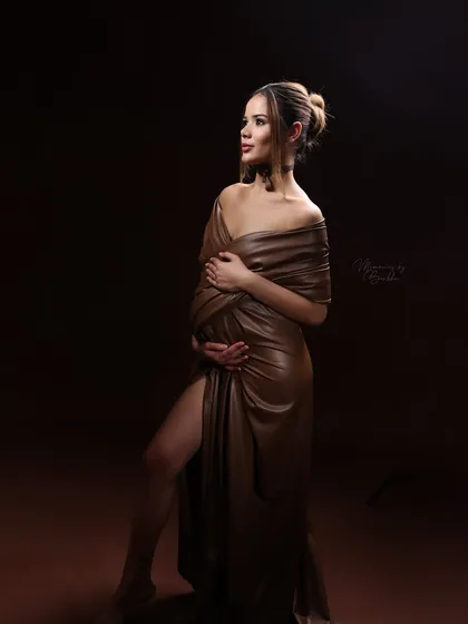 Ditch the florals, embrace the fierceness. This edgy leather-draped portrait proves that maternity fashion has no limits.