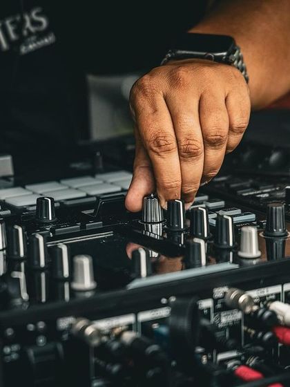 My hand on the crossfader, mixing between tracks. Every adjustment is about shaping the energy on the dance floor.