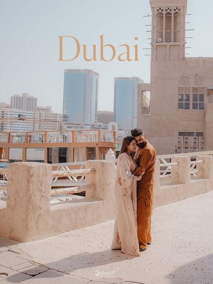 A pre-wedding shoot in Old Dubai, where the couple's traditional attire beautifully complements the rustic architecture.