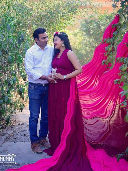 A sweet moment for the parents-to-be, sharing a look of love. Using a tiny teddy bear as a prop adds an adorable touch to this outdoor couple maternity shoot.