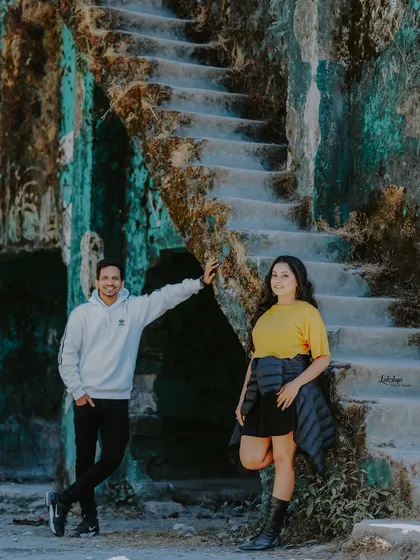 A stylish shot of the couple posing against the old, textured walls of a ruin in Mussoorie. I love finding unique, rustic spots that add character to the photos.