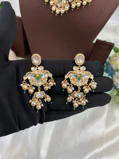 The 'Noor Nazaakat' earrings with green accents.