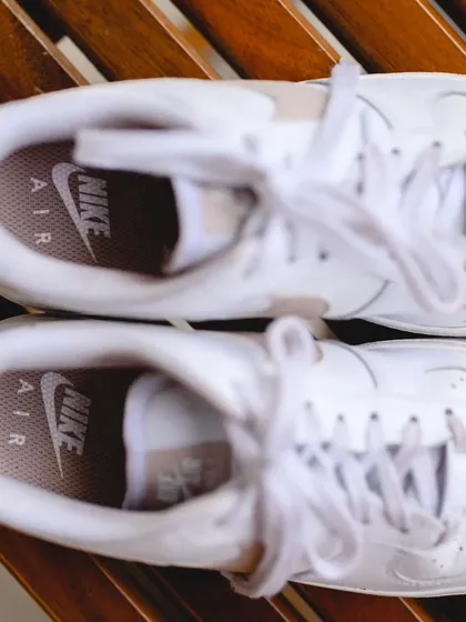 The bride's shoes. A top down shot of Disha's cool white Nike Air sneakers, a fun and unconventional choice that perfectly reflected her style.