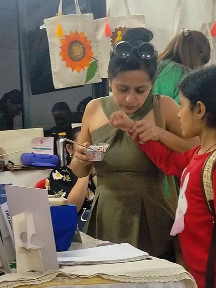 A mother and daughter trying out products at the Kalpavruksha event.