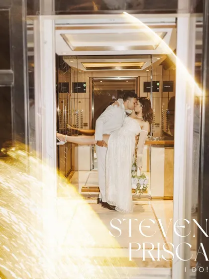 A creative and dramatic shot of Prisca and Steven sharing a kiss in an elevator, framed by a sparkler effect. This image is designed to be bold and memorable, capturing the high energy of their "I do" moment.