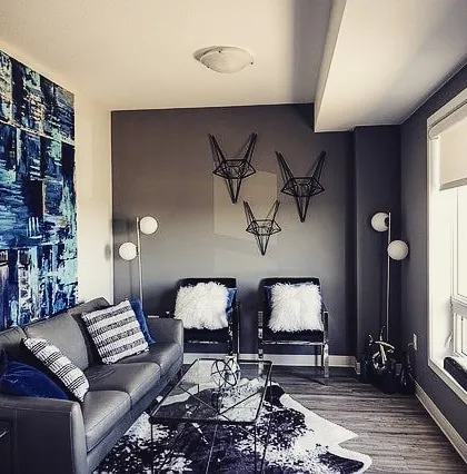 This living room features a large abstract blue and white canvas we created. The piece anchors the room's color scheme and adds a layer of texture and sophistication.