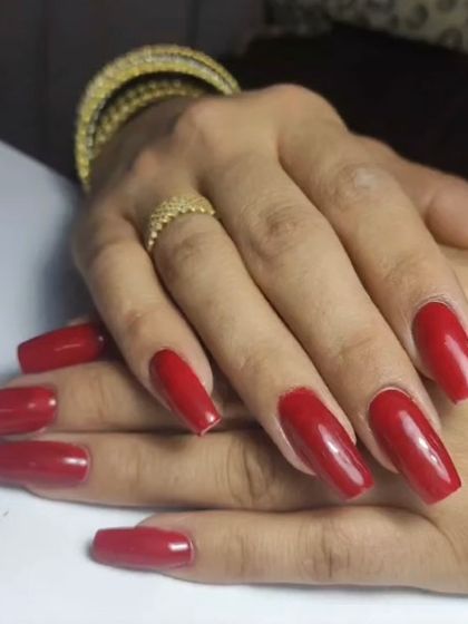 A vibrant, classic red on long, coffin-shaped nails. This is a go-to look for instant glamour.