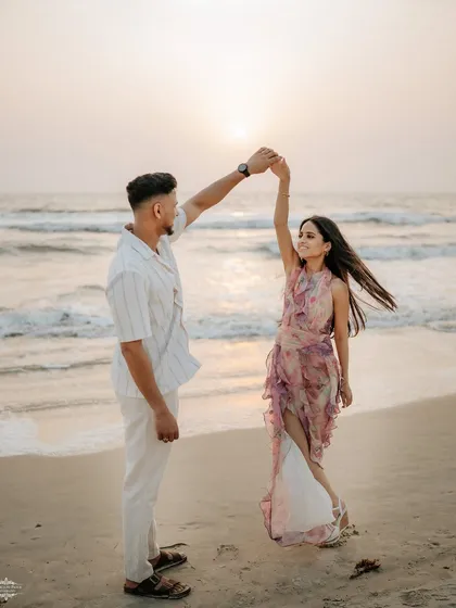 A couple dancing on the beach as the sun sets over the ocean in Goa. This image captures movement and romance in a beautiful destination setting.
