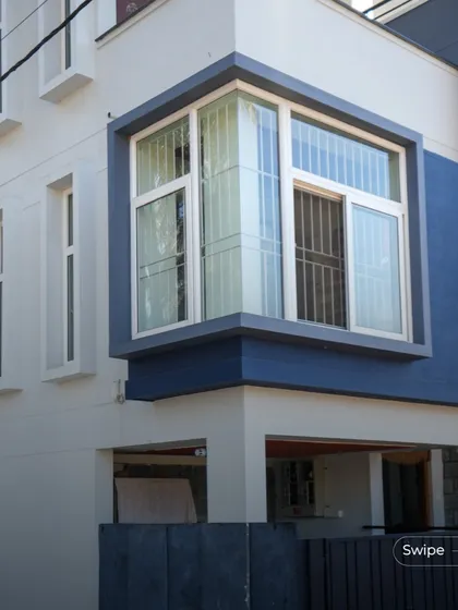 A close-up of the projecting bay window on the facade of the Shashidhar Residence, a feature that adds dimension to the exterior and creates a special space inside.