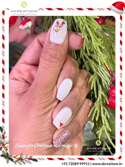 An elegant white Christmas manicure with a touch of sparkle, featuring a cute reindeer and a subtle Santa hat design on the accent nails.
