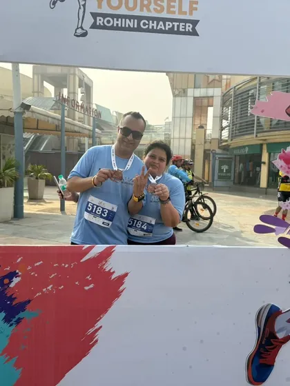 A couple celebrating their first 5k race together. A huge accomplishment and the start of a new fitness journey.