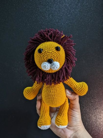 A clear, straight-on view of the handmade lion toy.