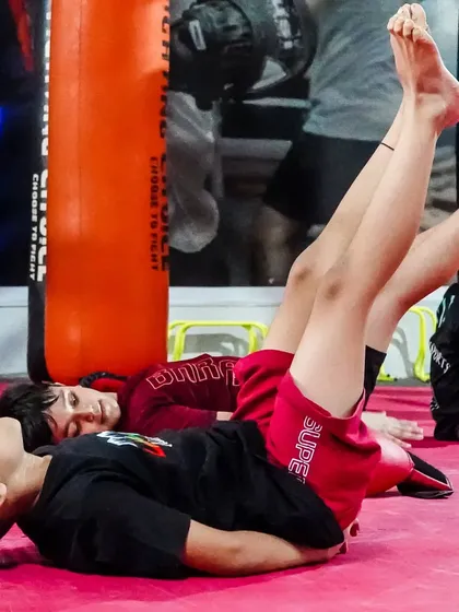 Core strength is fundamental for any athlete. Here, our young students are doing leg raises, building a strong foundation for all their martial arts movements.