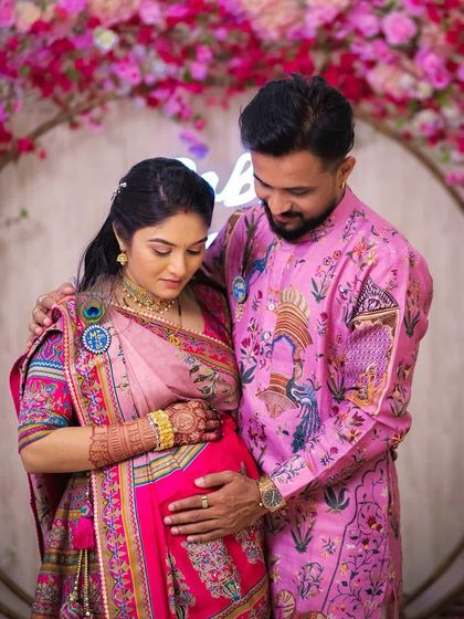 This is another tender moment from the same baby shower. It shows how the coordinated pink outfits create a harmonious and picture-perfect look for celebrating a new beginning.