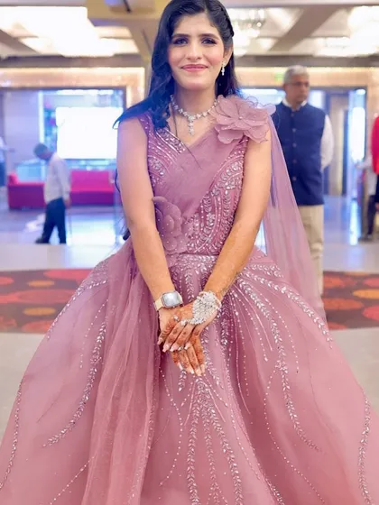 The full view of the stunning pink gown. The makeup is designed to be picture-perfect for any party.