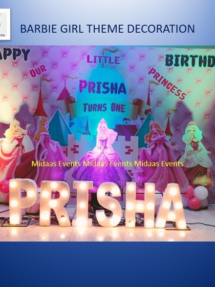 A closer, brightly lit view of the Barbie princess theme for Prisha. The soft pink lighting and quilted-effect backdrop create a dreamy and magical feel for a first birthday celebration.