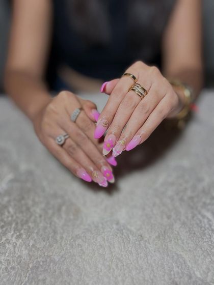 A close-up of the pink ombre and marble nails, showing the subtle details and gold flakes.