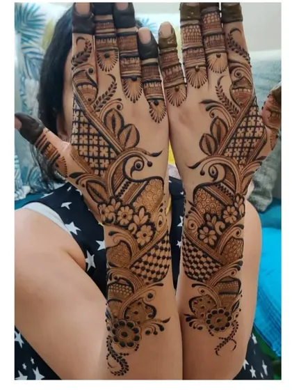 A gorgeous design centered around symmetrical peacock motifs. The birds are surrounded by a mix of floral and geometric patterns, creating a full and balanced look.