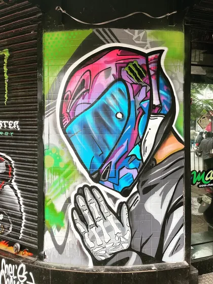A clean shot of the finished helmet artwork. The mix of vibrant colors and sharp lines makes this a standout piece that draws attention from the street.