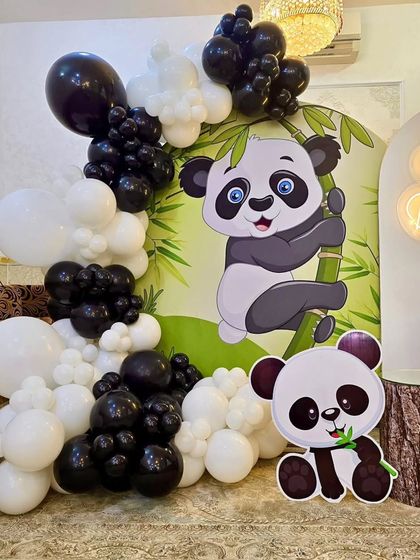 A close-up of the black and white balloon garland and the panda cutouts.
