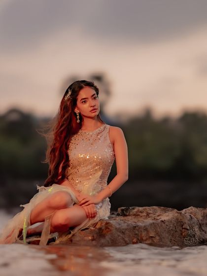 This photo captures the romantic, thoughtful mood of the music video. Anushka's pose by the water, with the dress gently pooled around her, feels like a scene from a fairytale.