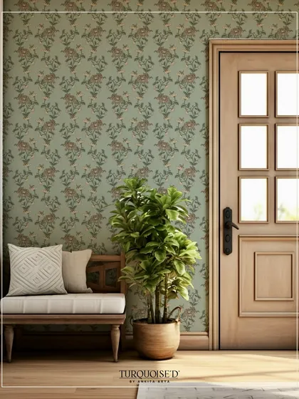 The Malkha Jaal wallpaper in a soft sage green provides a beautiful, nature-inspired backdrop for an entryway. The delicate floral and elephant motifs add a layer of storytelling and traditional art.