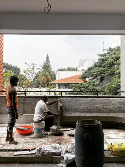 A work-in-progress shot from a terrace construction. We believe in being on-site to oversee the details, like the creation of this curved, built-in seating, ensuring the craftsmanship matches the design intent.