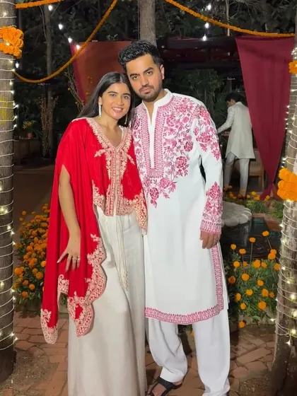 A client in a custom white kurta with pink embroidery, inspired by a popular celebrity look.